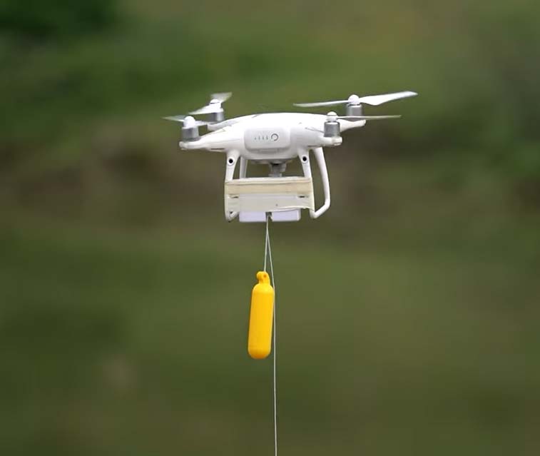 drone flying in air with yellow cylinder to carry samsung phone to air